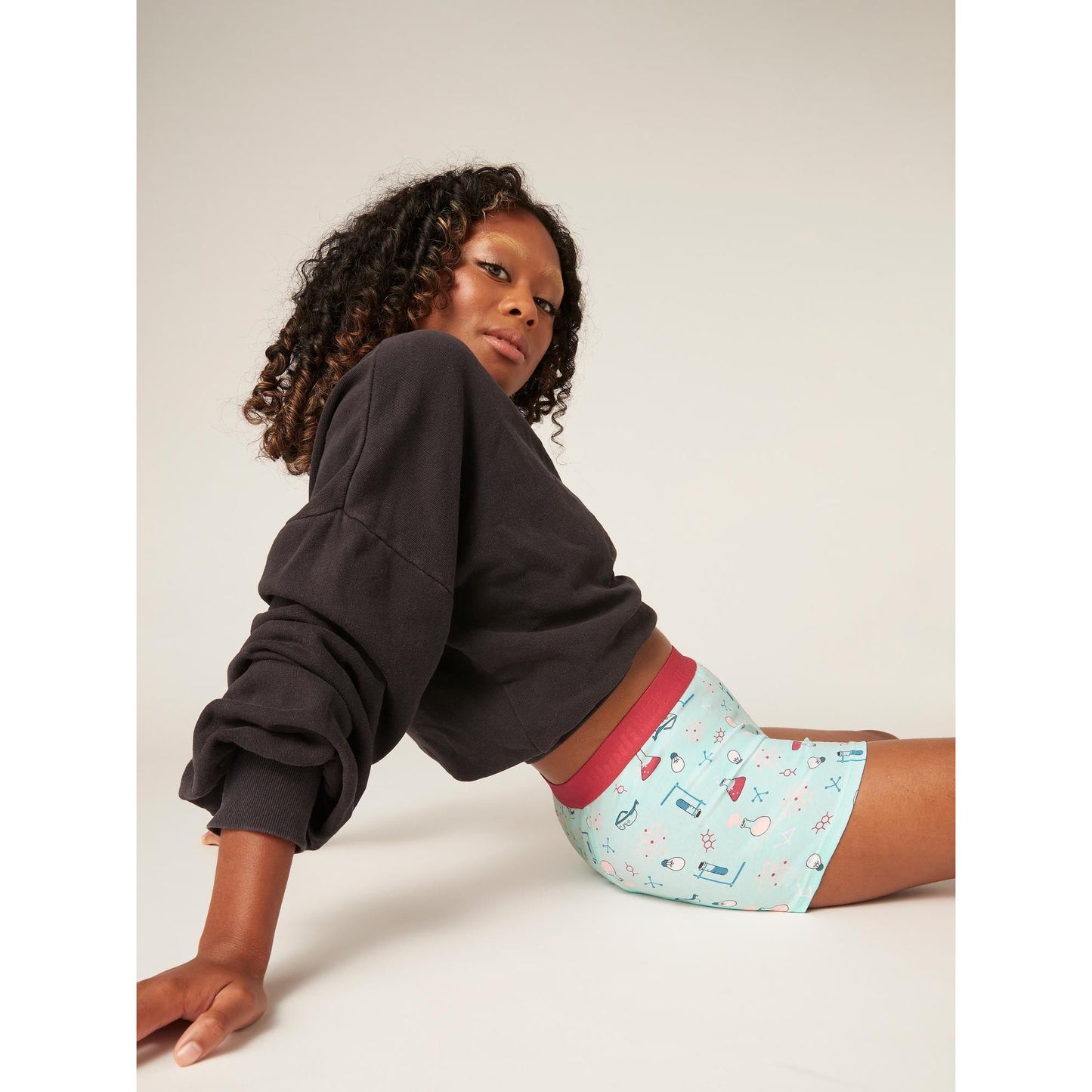 Girl sitting down wearing modibodi boyshort