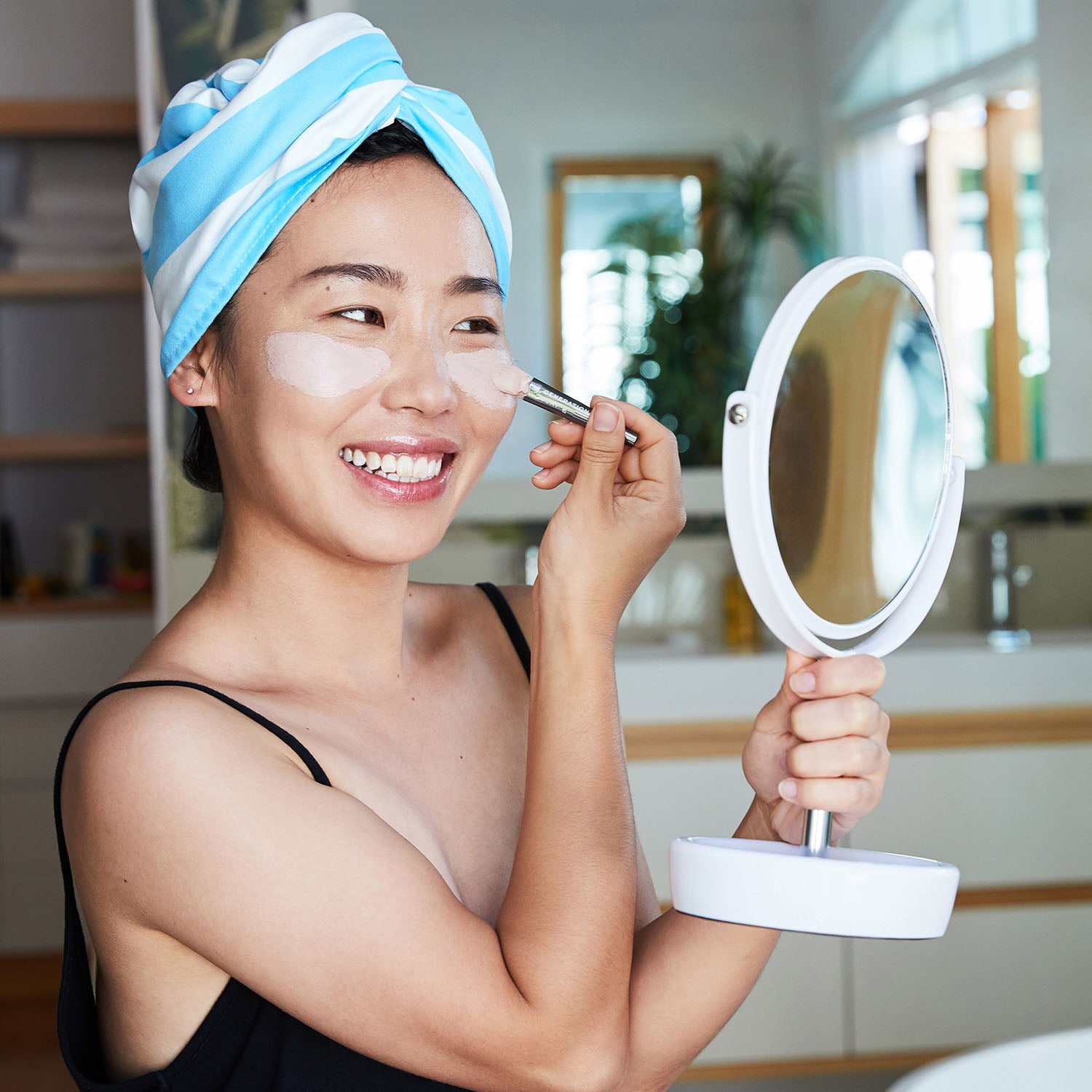 Girls applying makeup wearing hairwrap 