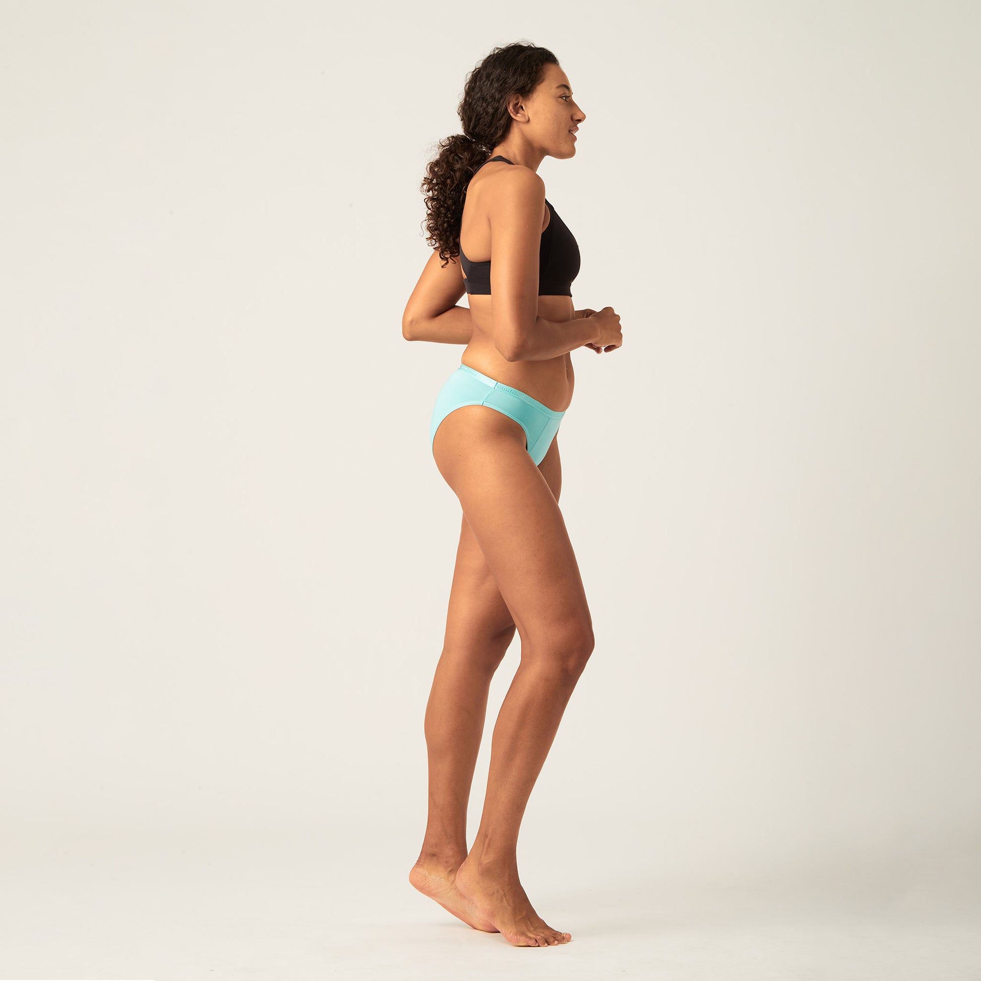 Sporty Girl standing wearing Modibodi Leak Proof Underwear