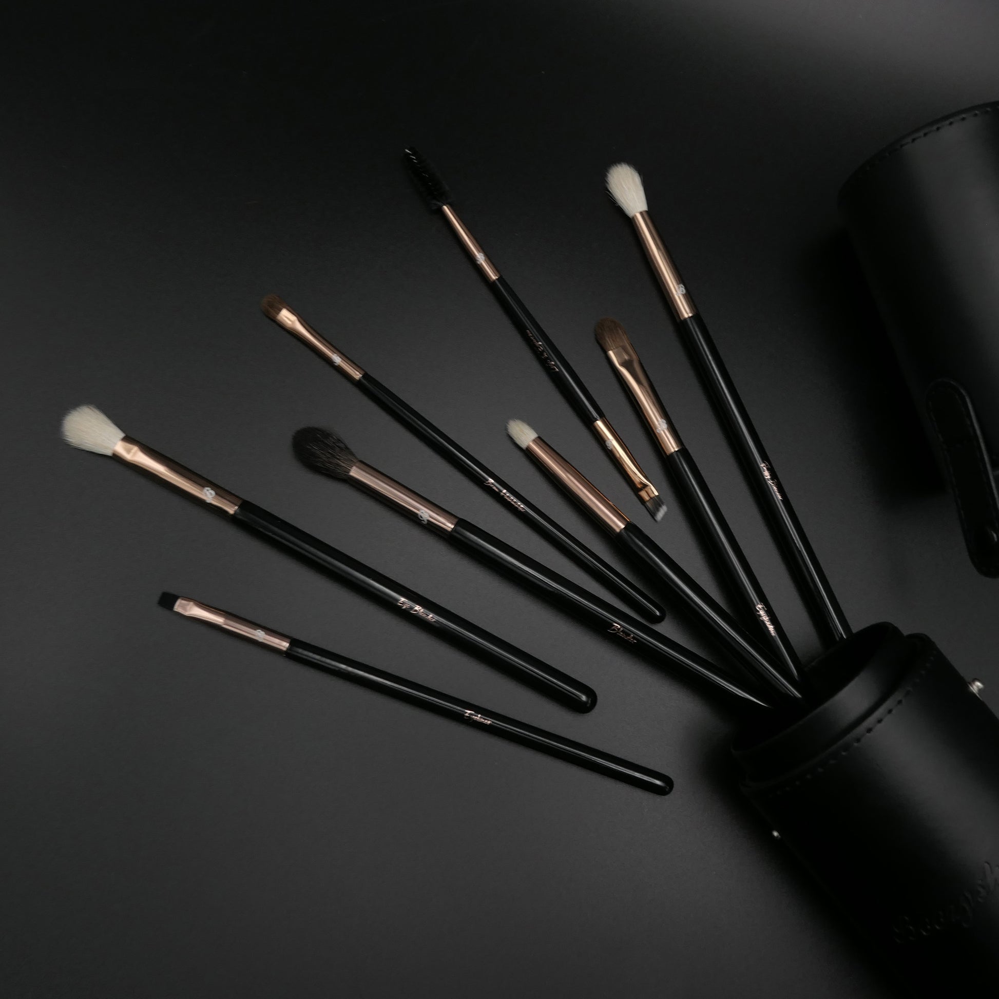 Black handles with a variety of fibres. 